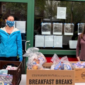 Brick House Community Resource Center staff members distribute food in front of its building in Turner Falls, Mass.