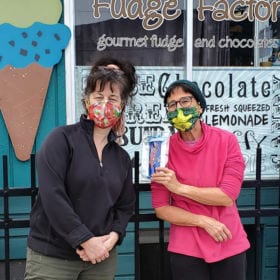 Sue Kranz (in pink) with Michelle Olanyk, owner of Mo’s Fudge Factor in Shelburne Falls. Olanyk displayed Kranz’s free masks in her store in exchange for donations.